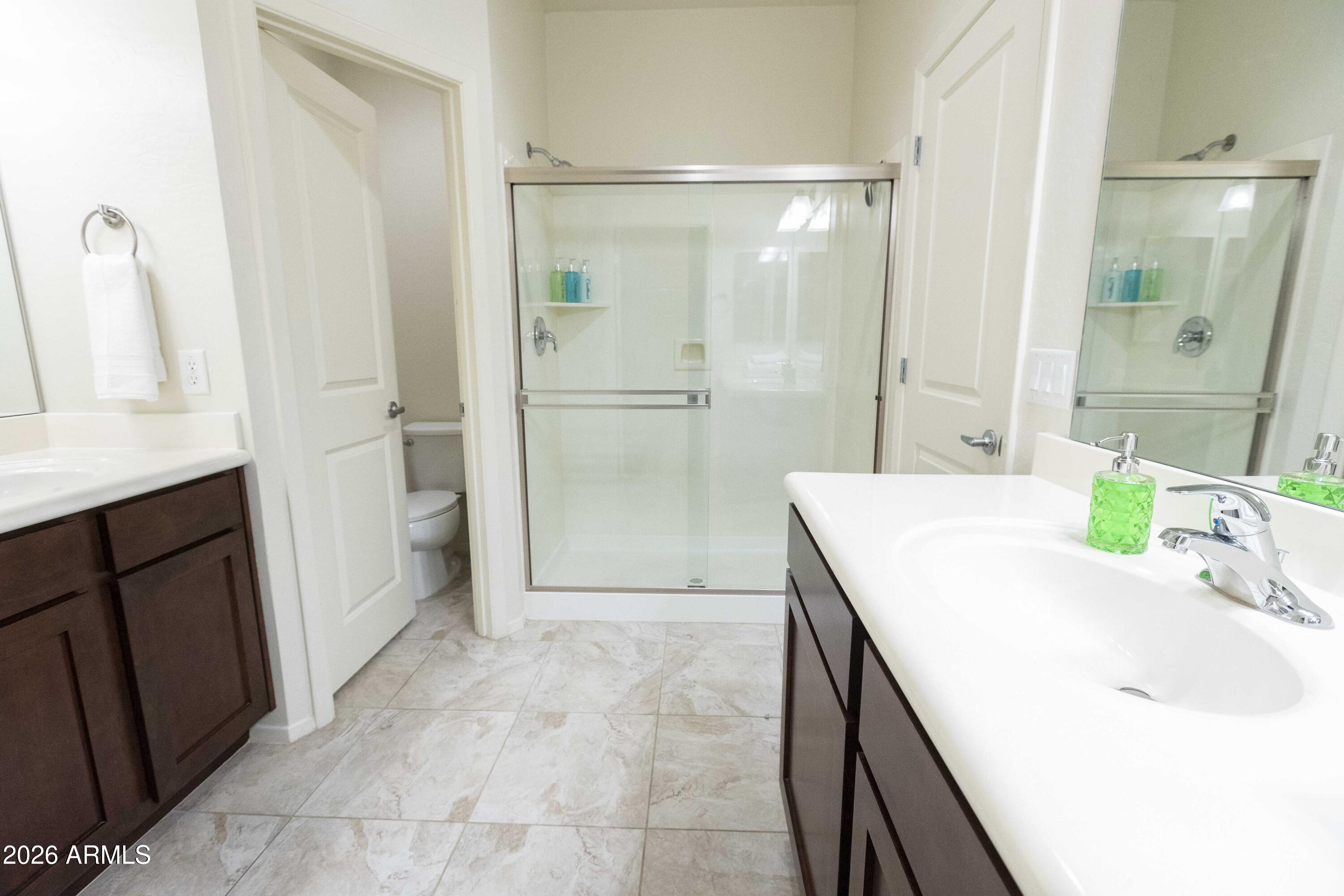3113 East Danbury Road, Unit 22 Phoenix, AZ 85032 - Photo 10 of 17 a bathroom with a granite countertop sink a mirror and a shower