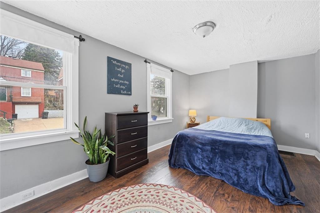 1414 Brinton Road Pittsburgh, PA 15221 - Photo 14 of 20 a bedroom with a large bed and a potted plant