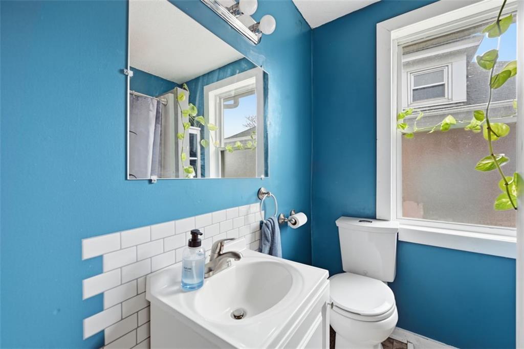 1414 Brinton Road Pittsburgh, PA 15221 - Photo 15 of 20 a bathroom with a sink mirror vanity and toilet