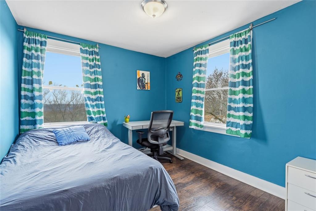 1414 Brinton Road Pittsburgh, PA 15221 - Photo 18 of 20 a bedroom with a bed and a window