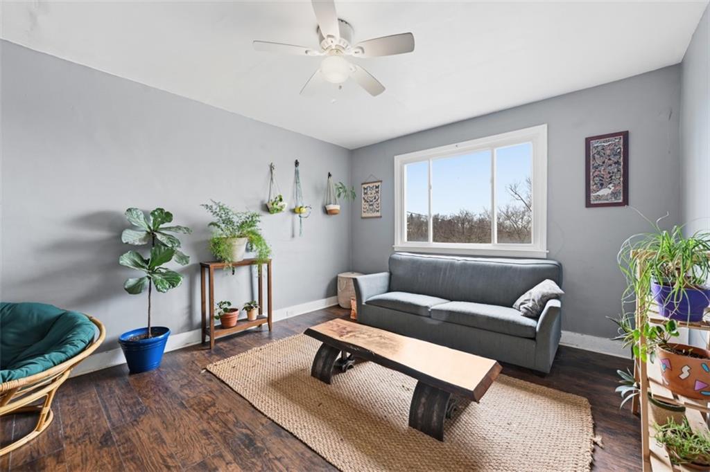 1414 Brinton Road Pittsburgh, PA 15221 - Photo 6 of 20 a living room with furniture and a potted plant