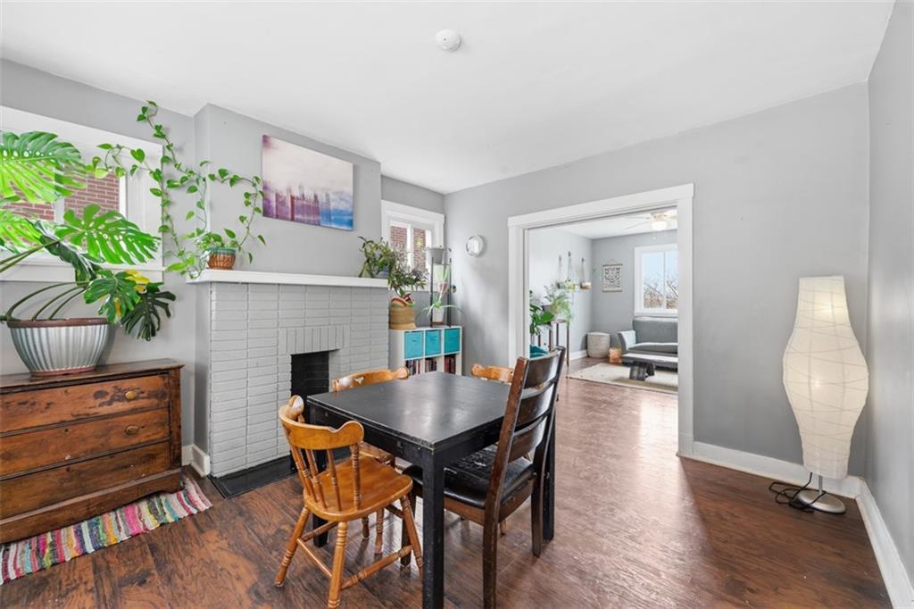 1414 Brinton Road Pittsburgh, PA 15221 - Photo 8 of 20 a view of a dining room with furniture and a fireplace