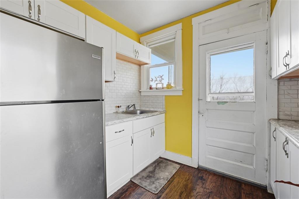 1414 Brinton Road Pittsburgh, PA 15221 - Photo 10 of 20 a bathroom with a granite countertop sink a mirror and a bathtub