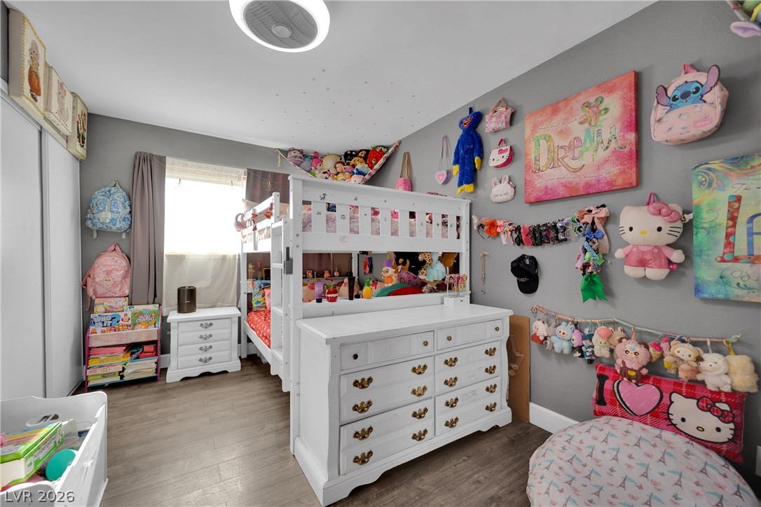 2221 Englestad Street North Las Vegas, NV 89030 - Photo 23 of 32 This cozy bedroom features durable flooring and a luminous ceiling light, creating a cheerful atmosphere.