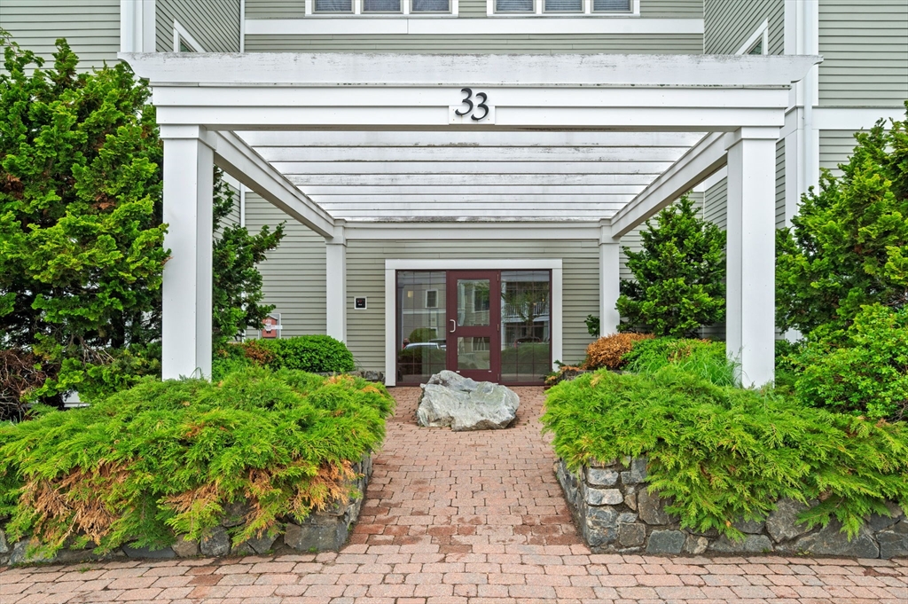 33 Intrepid Circle, Unit 405 Marblehead, MA 01945 - Photo 3 of 31 a front view of a house with garden