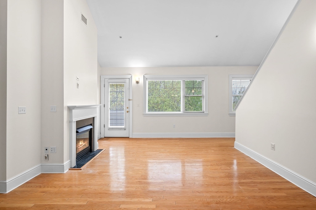 33 Intrepid Circle, Unit 405 Marblehead, MA 01945 - Photo 8 of 31 a view of an empty room with a window and fireplace