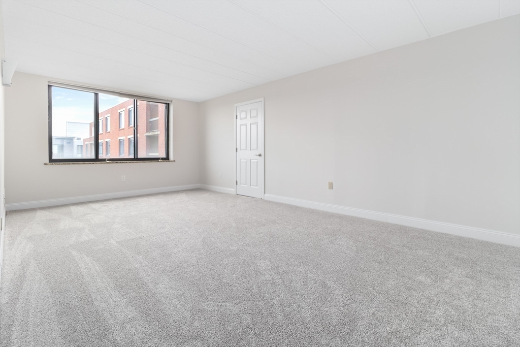85 Brainerd Road, Unit 507 Boston, MA 02134 - Photo 11 of 23 a view of an empty room with a window