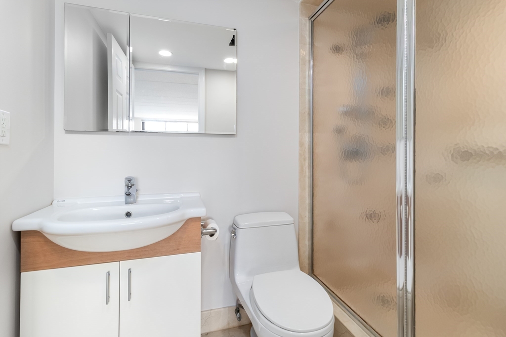 85 Brainerd Road, Unit 507 Boston, MA 02134 - Photo 13 of 23 a bathroom with a sink a toilet and shower