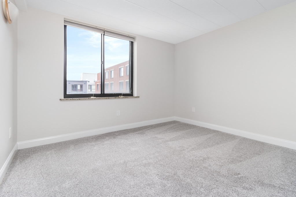 85 Brainerd Road, Unit 507 Boston, MA 02134 - Photo 14 of 23 an empty room with a window