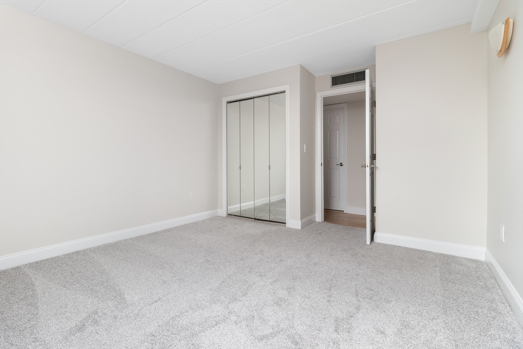 85 Brainerd Road, Unit 507 Boston, MA 02134 - Photo 15 of 23 a view of an empty room and closet area
