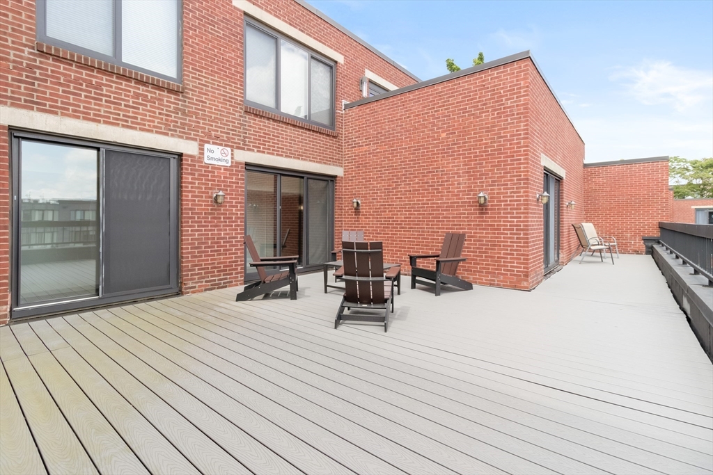 85 Brainerd Road, Unit 507 Boston, MA 02134 - Photo 20 of 23 a view of a terrace with chairs