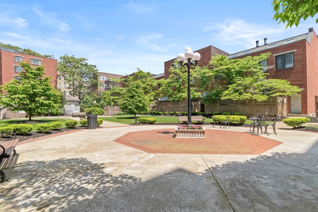 85 Brainerd Road, Unit 507 Boston, MA 02134 - Photo 21 of 23 a wooden bench sitting in front of a building