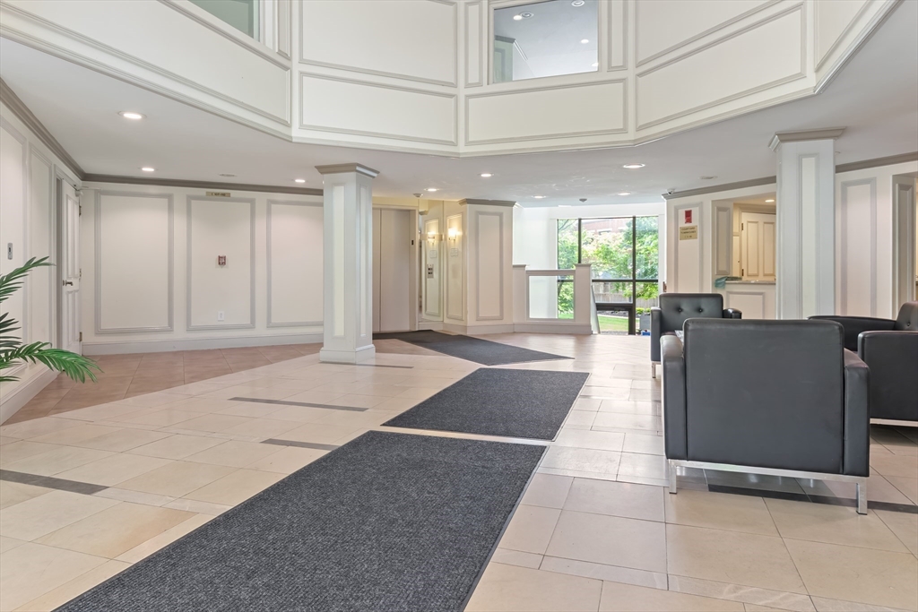 85 Brainerd Road, Unit 507 Boston, MA 02134 - Photo 4 of 23 a lobby with furniture and window