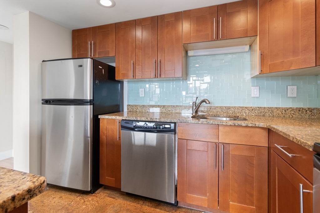 85 Brainerd Road, Unit 507 Boston, MA 02134 - Photo 10 of 23 a kitchen with a refrigerator sink and cabinets