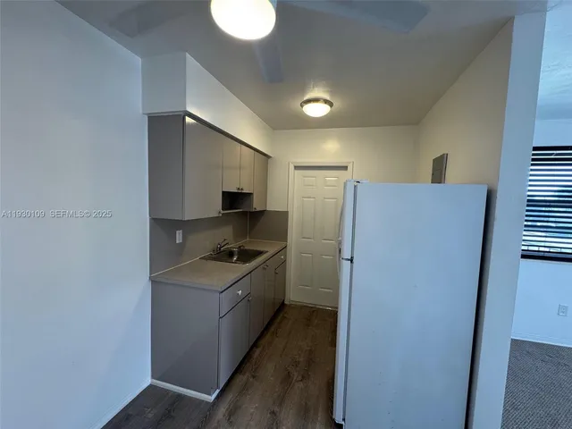 a kitchen with a refrigerator and a sink
