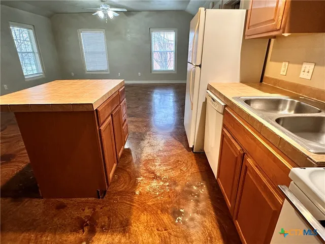 a view of a kitchen with a sink and dishwasher