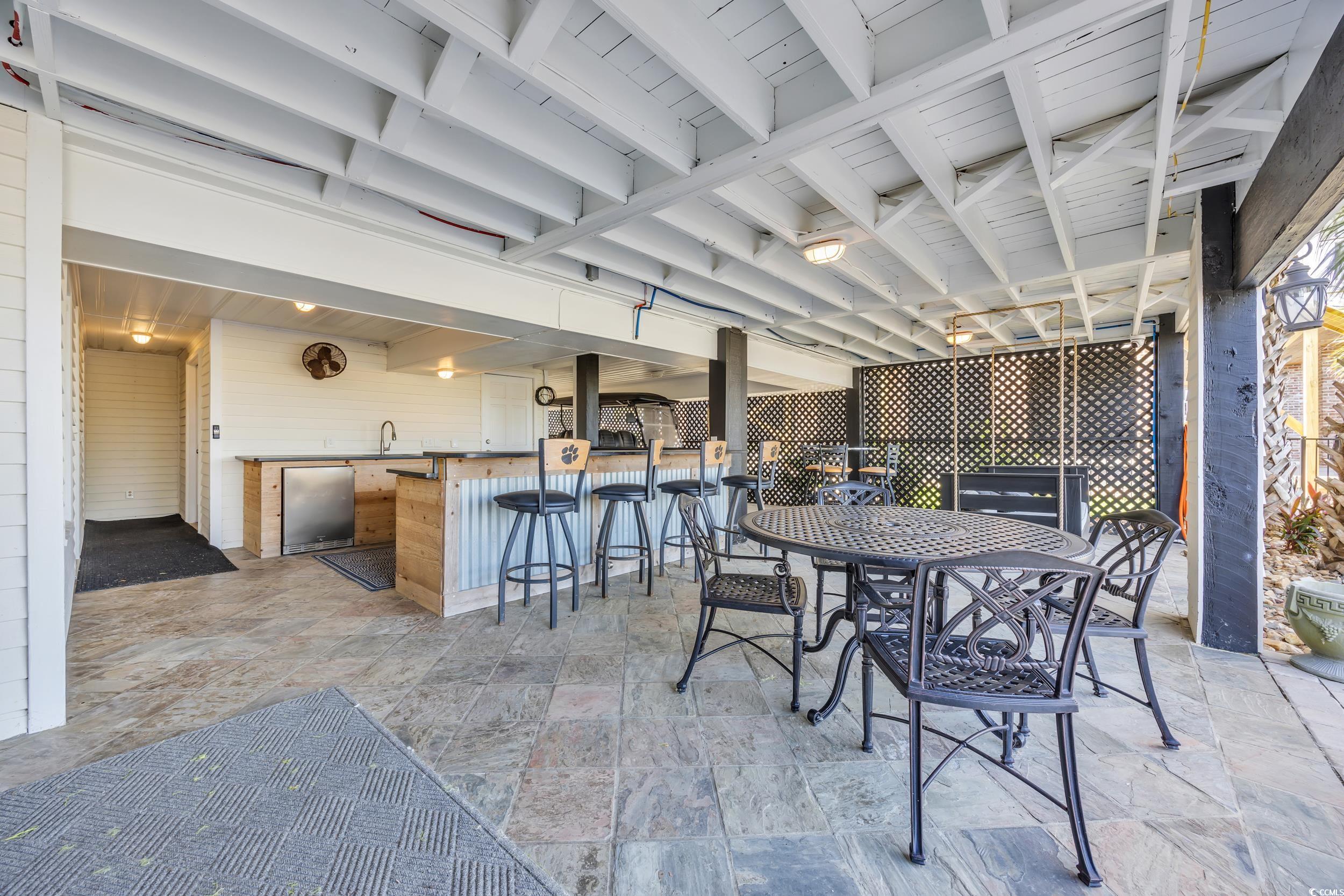 1332 South Waccamaw Drive Murrells Inlet, SC 29576 - Photo 15 of 39 View of patio featuring outdoor dining area