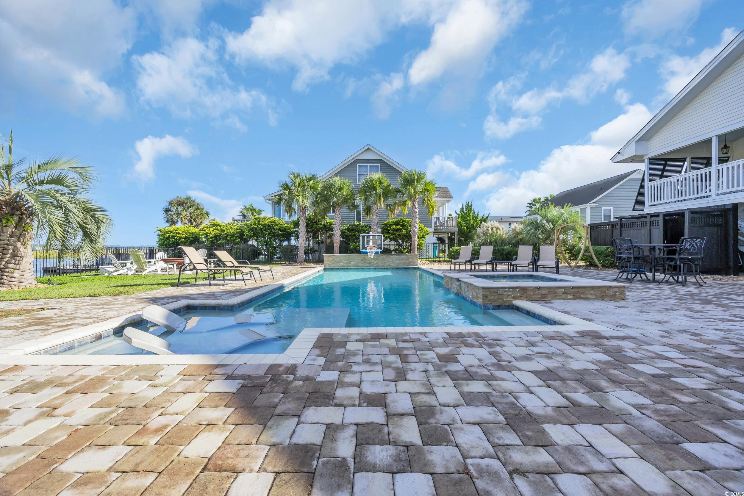 1332 South Waccamaw Drive Murrells Inlet, SC 29576 - Photo 18 of 39 View of swimming pool with a patio area and a pool with connected hot tub