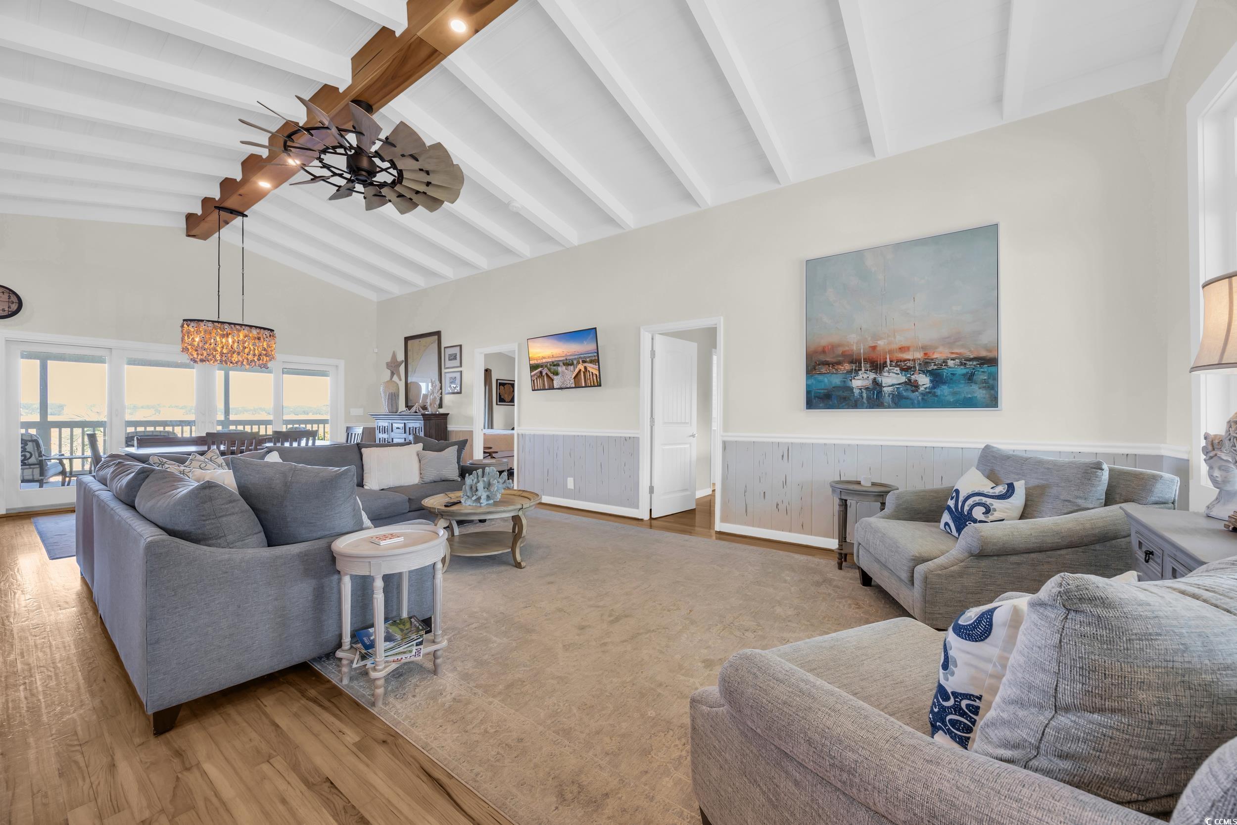 1332 South Waccamaw Drive Murrells Inlet, SC 29576 - Photo 24 of 39 Living area featuring wood finished floors, beam ceiling, a ceiling fan, a chandelier, and high vaulted ceiling