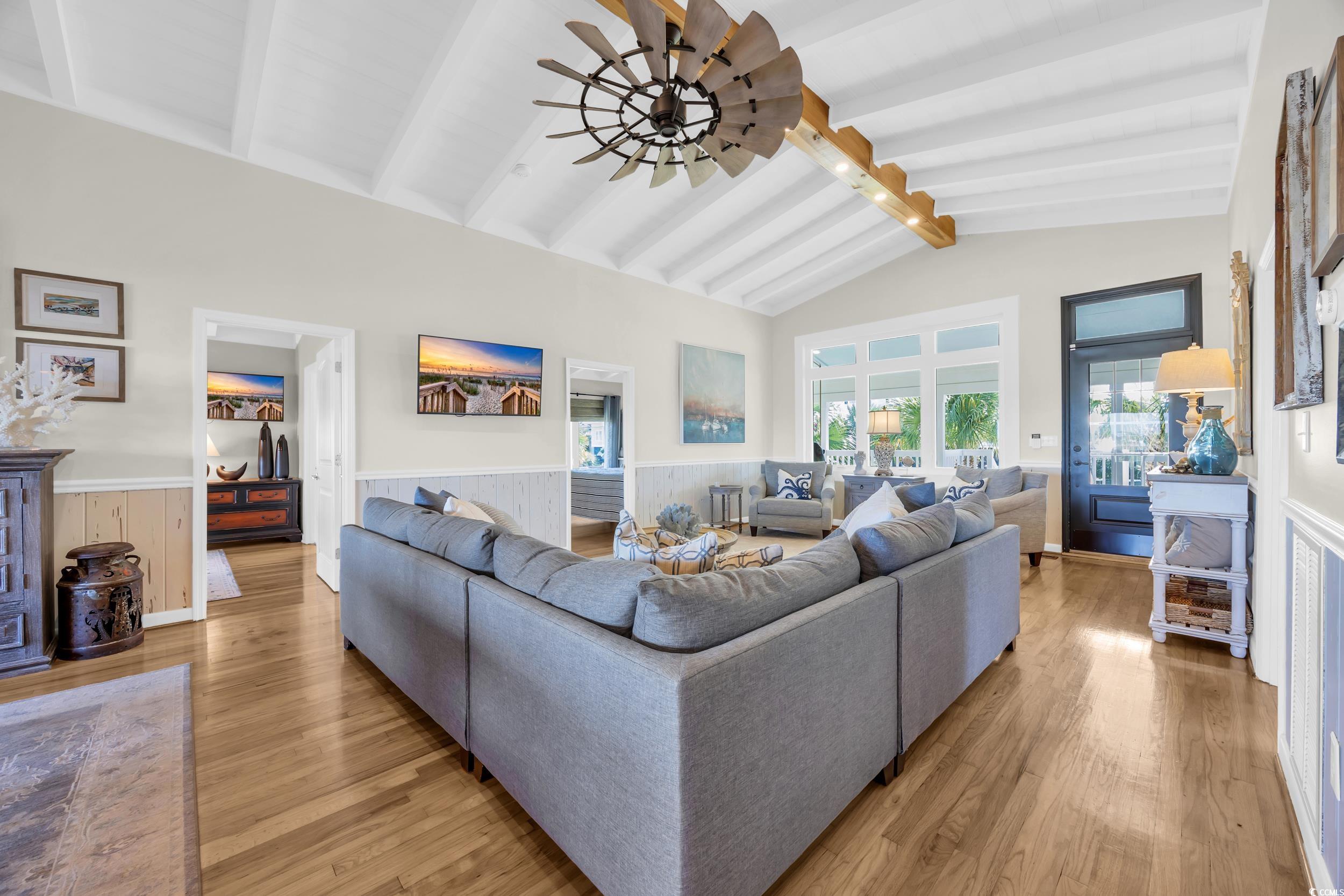1332 South Waccamaw Drive Murrells Inlet, SC 29576 - Photo 27 of 39 Living room featuring wood finished floors, a wainscoted wall, and a ceiling fan