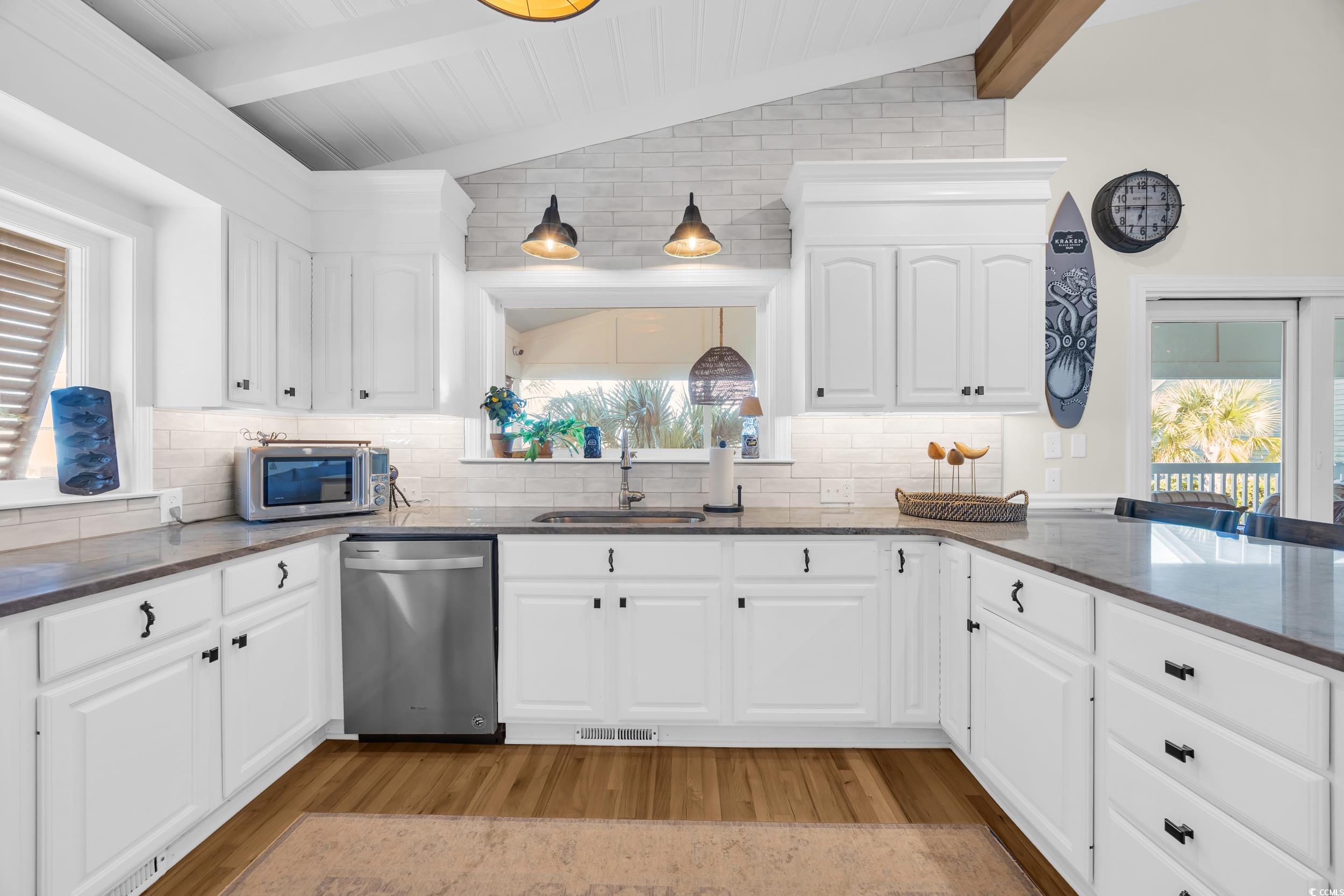 1332 South Waccamaw Drive Murrells Inlet, SC 29576 - Photo 30 of 39 Kitchen featuring dark stone countertops, stainless steel appliances, and tasteful backsplash