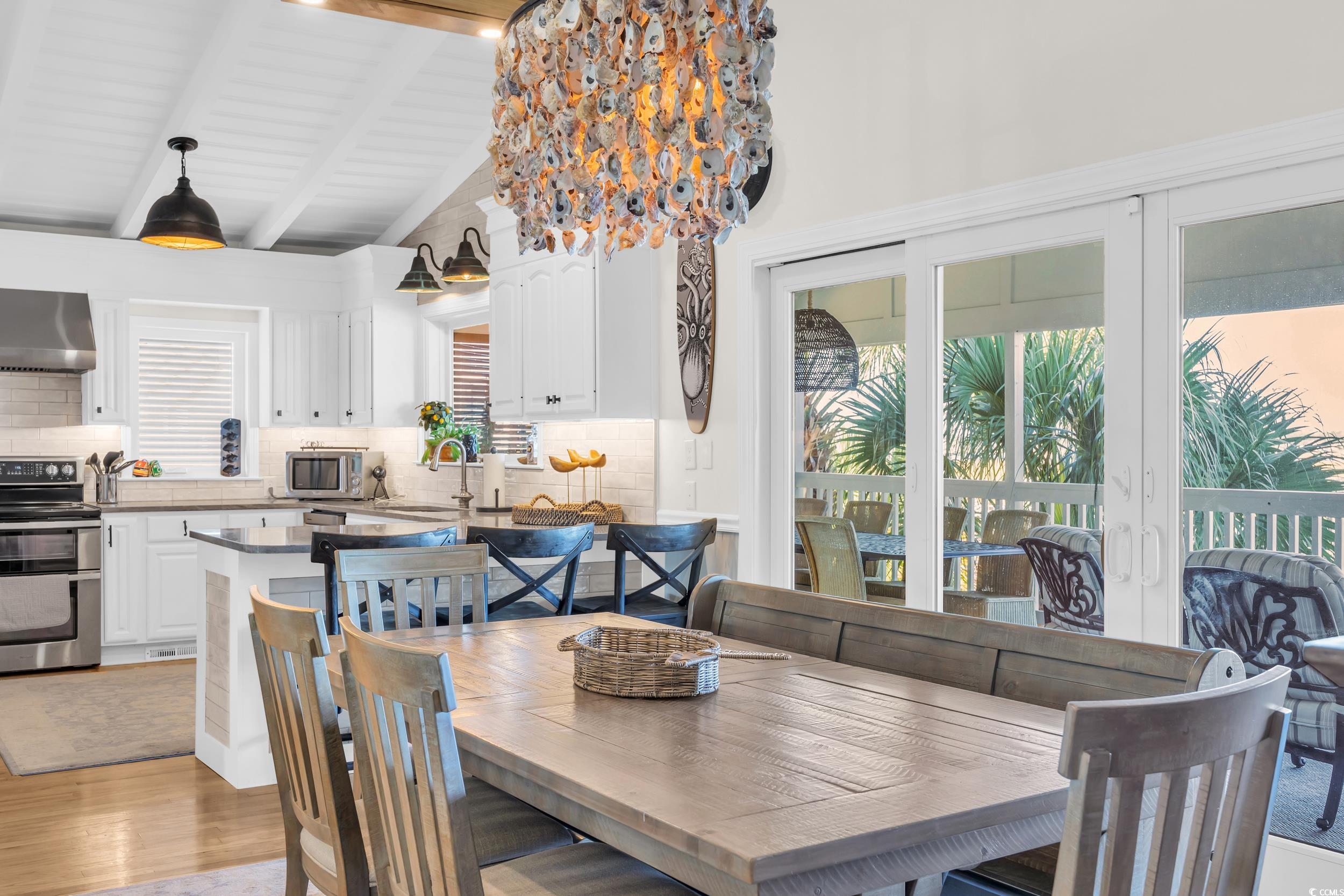 1332 South Waccamaw Drive Murrells Inlet, SC 29576 - Photo 33 of 39 Dining room featuring beamed ceiling, light wood-style floors, and high vaulted ceiling