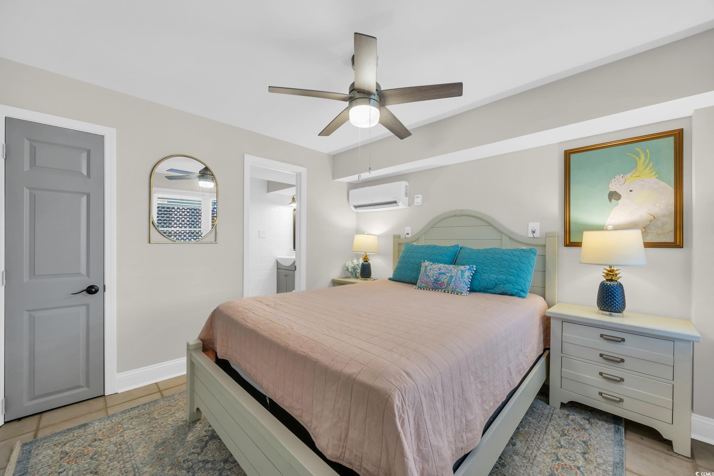 1332 South Waccamaw Drive Murrells Inlet, SC 29576 - Photo 39 of 39 Bedroom with light tile patterned floors, ceiling fan, an AC wall unit, and connected bathroom