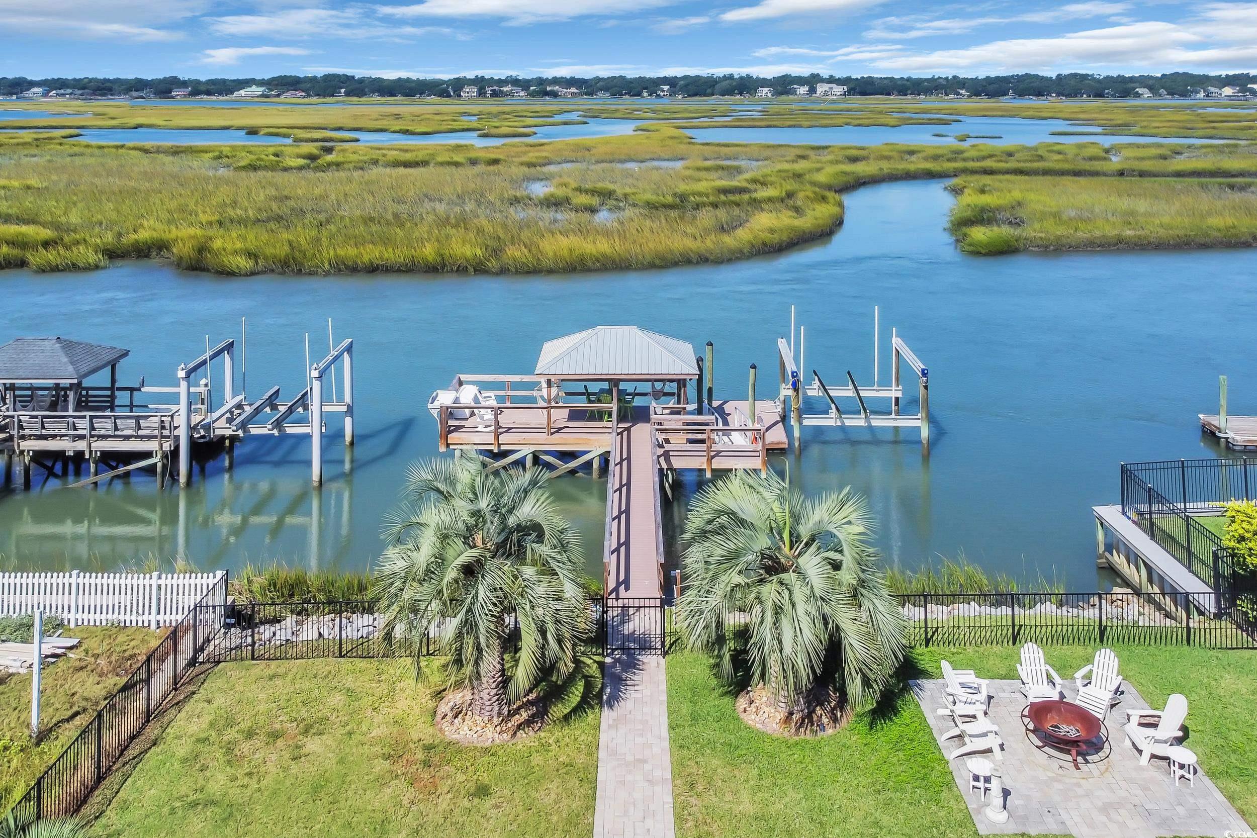 1332 South Waccamaw Drive Murrells Inlet, SC 29576 - Photo 7 of 39 Dock featuring a water view, an outdoor fire pit, and boat lift