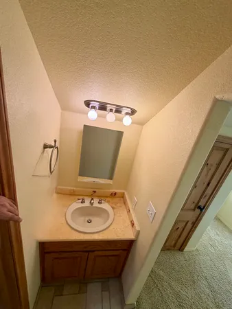 a bathroom with a sink mirror and toilet