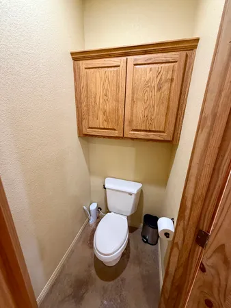 a white toilet sitting next to a shower