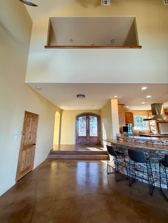 a living room with a table chairs and a pool table