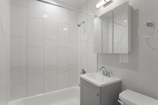 a bathroom with a toilet sink shower and mirror