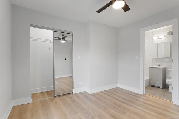 an empty room with closet and windows