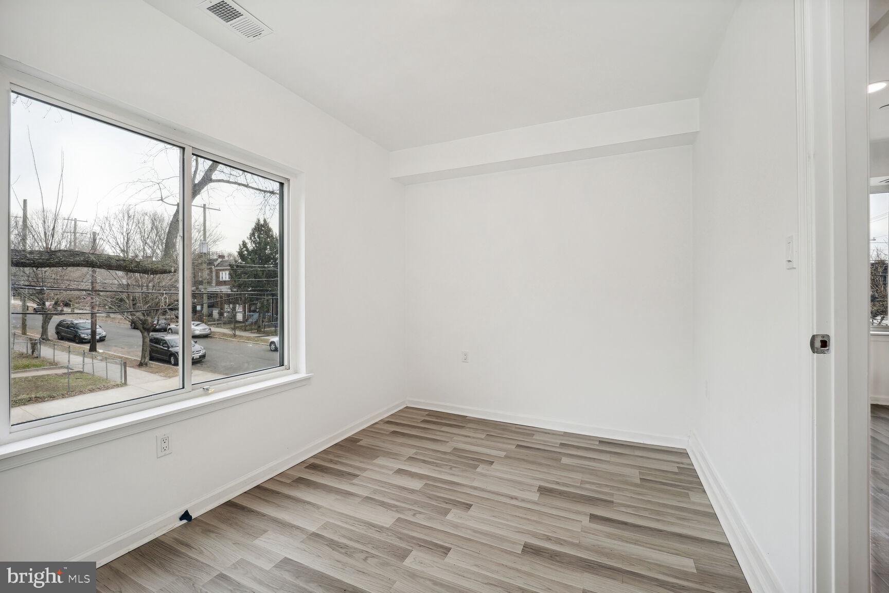 1642 16th Street Southeast, Unit 3 Washington, DC 20020 - Photo 14 of 22 a view of a room with wooden floor and a window