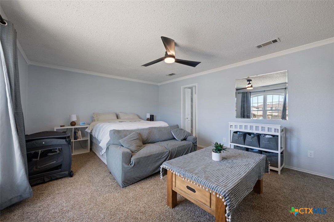 2307 Bernice Circle Copperas Cove, TX 76522 - Photo 20 of 32 a bedroom with a bed and a chandelier