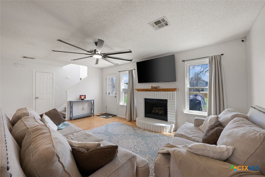 2307 Bernice Circle Copperas Cove, TX 76522 - Photo 8 of 32 a living room with furniture a fireplace and a flat screen tv