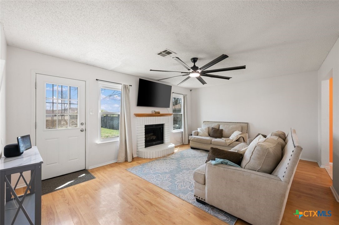 2307 Bernice Circle Copperas Cove, TX 76522 - Photo 9 of 32 a living room with furniture a fireplace and a flat screen tv