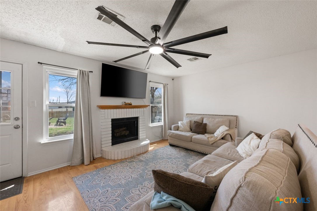 2307 Bernice Circle Copperas Cove, TX 76522 - Photo 10 of 32 a living room with furniture a flat screen tv and a fireplace