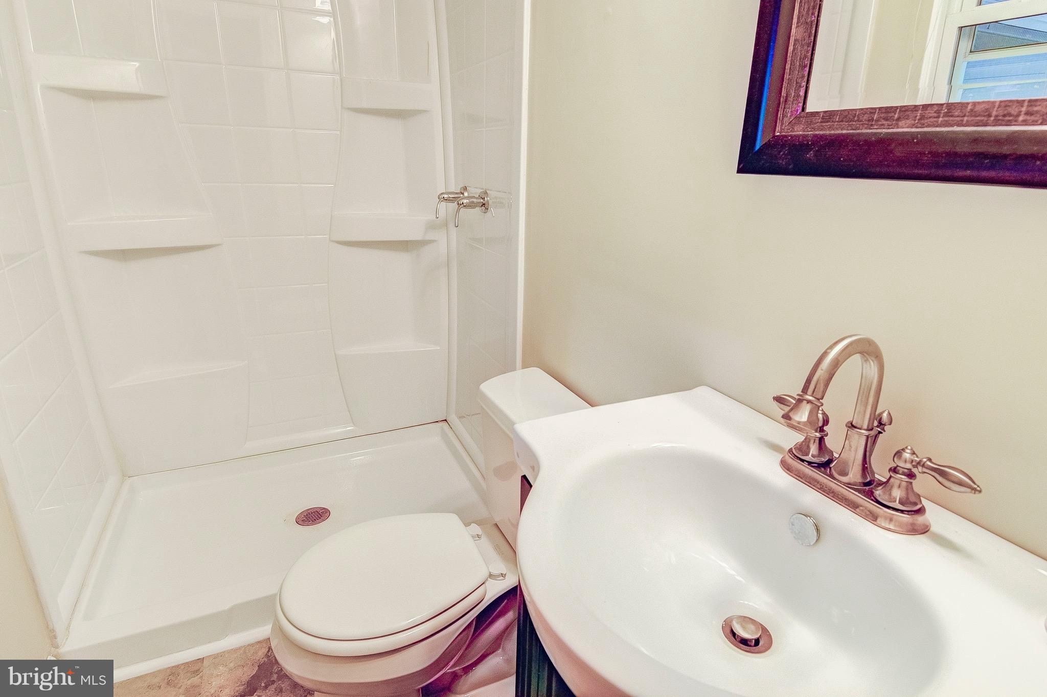 2616 Apple Way Dunkirk, MD 20754 - Photo 19 of 29 a bathroom with a sink a toilet and shower