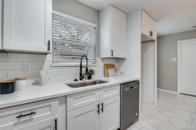 a kitchen with a sink and a window