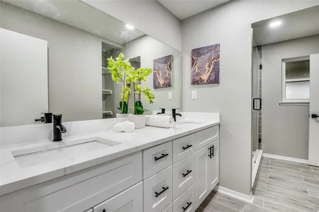 a bathroom with a sink double vanity and a mirror