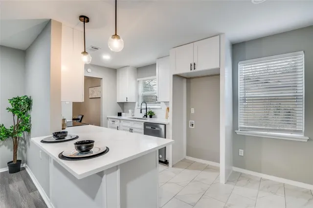 a kitchen with sink cabinets and stove