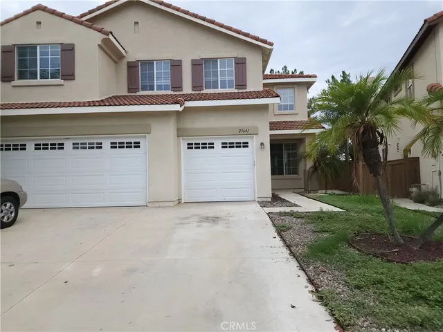 a view of a house with a yard and garage