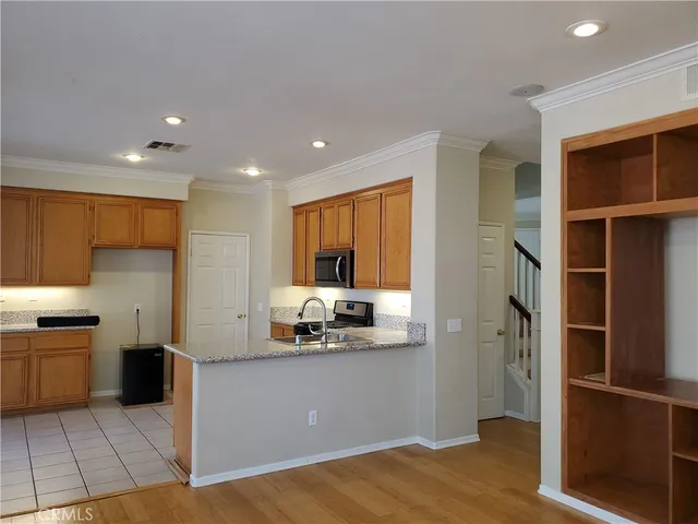 a kitchen with stainless steel appliances granite countertop a refrigerator and a sink