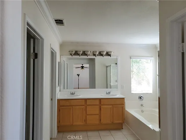 a bathroom with a bathtub sink and mirror