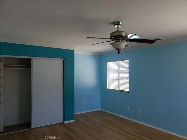 a view of a chandelier fan and wooden floor