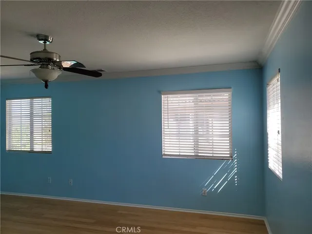 a view of a room with wooden floor and windows