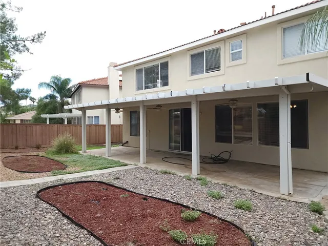 a view of a house with a yard and sitting space