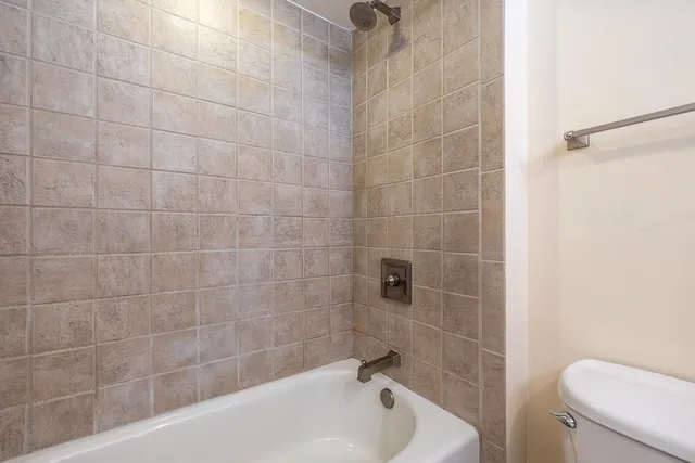 a bathroom with a bathtub and a toilet