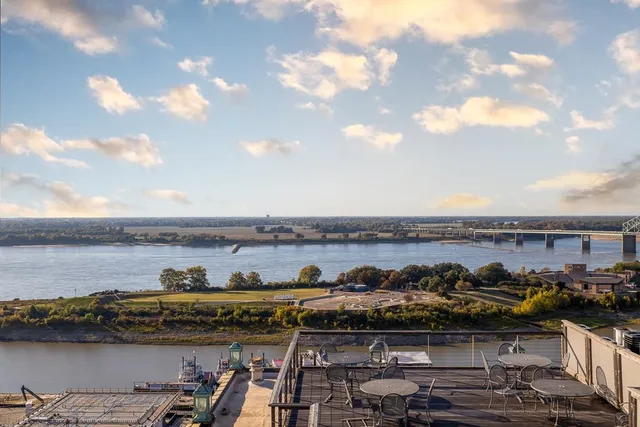 a view of a patio with table and chairs a barbeque with wooden floor and fence